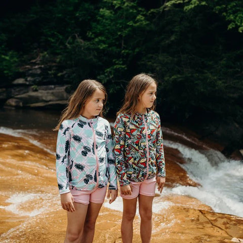 Two girls in the SwimZip rash guards at the river bank—Best rash guards