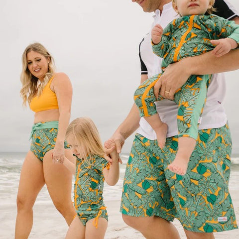 Family in the Tropics matching sun-protective swimwear collection walk around the beach—How long does it take to tan in UV 6?