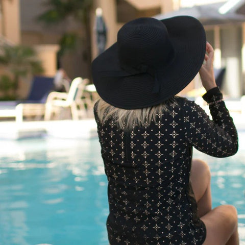 Woman in a SwimZip swimwear by the pool—How to get rid of sun tan.