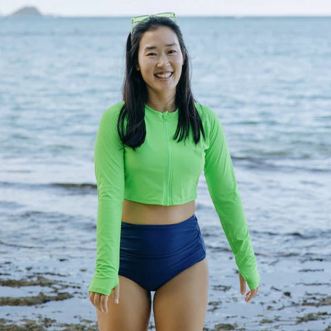 Woman in a SwimZip neon green rash guard—Best rash guards