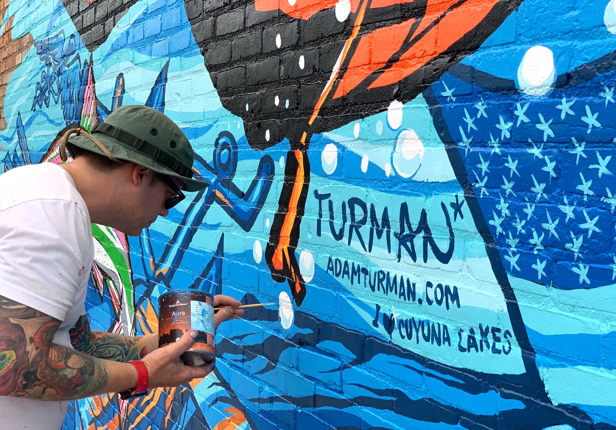 Adam Turman Cuyuna Lakes Search It Mural Adam Signing Mural
