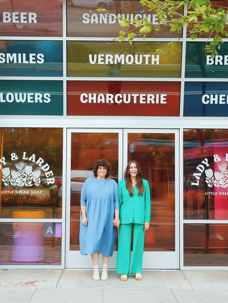 Sarah and Boo Simm standing in front of their Santa Monica Shop with rainbow windows