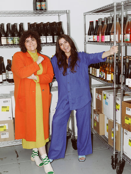 Sarah and Boo Simms standing in wine room at cheese shop