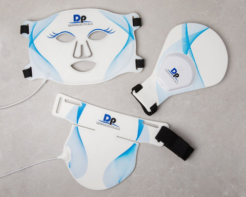 An array of advanced red light therapy devices from DP DermaCeuticals, including a facial mask and handheld units, designed for anti-aging treatment