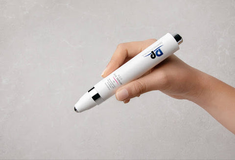Hand holding a white retinol skincare product with a minimalist design, showcasing a non-irritating formula suitable for sensitive skin.