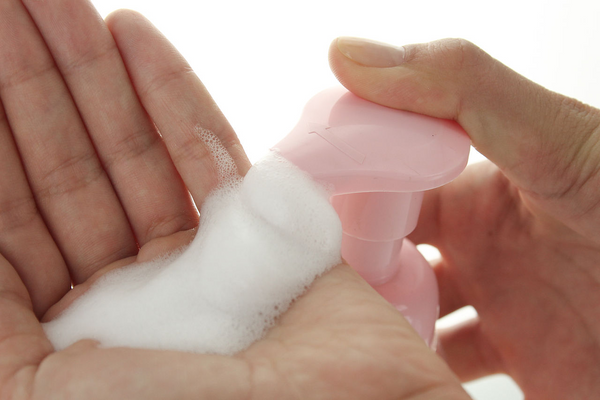 foam cleanser poured on left hand