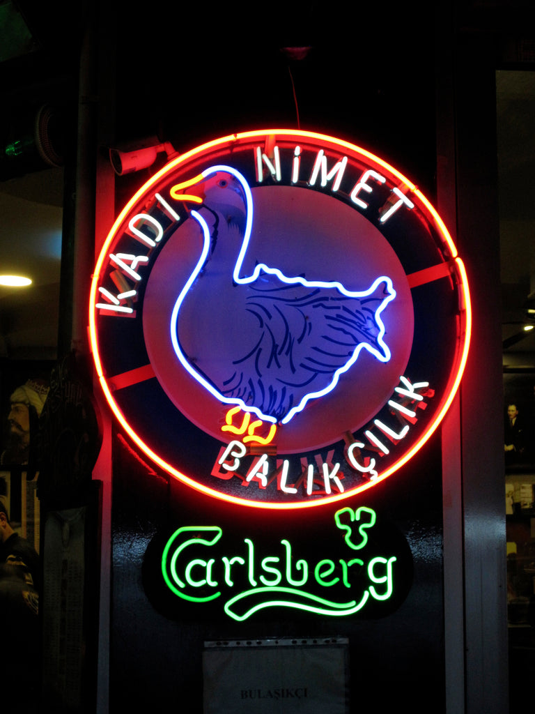 Photo of the neon sign with goose logo of the restaurant Kadi Nimet in Istanbul.