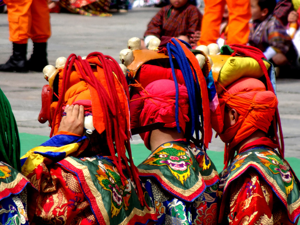 Masked dancers in the Thendralthang courtyard at the Thimpu Tshechu festival.