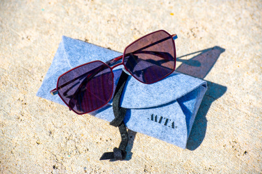 purple sunglasses placed in sunlight