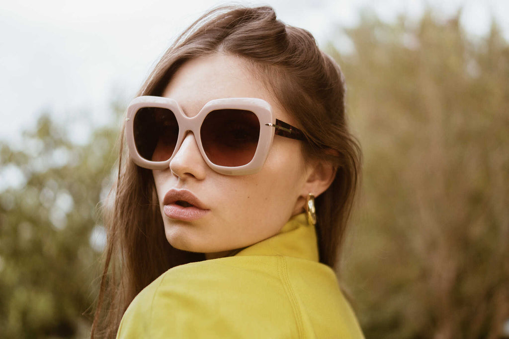 woman in yellow jacket and pink sunglasses