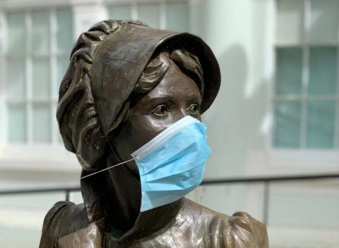 Jane Austen statue wearing a medical mask 