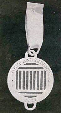Badge of the Sublime Society: a gridiron and the motto "Beef and Liberty".