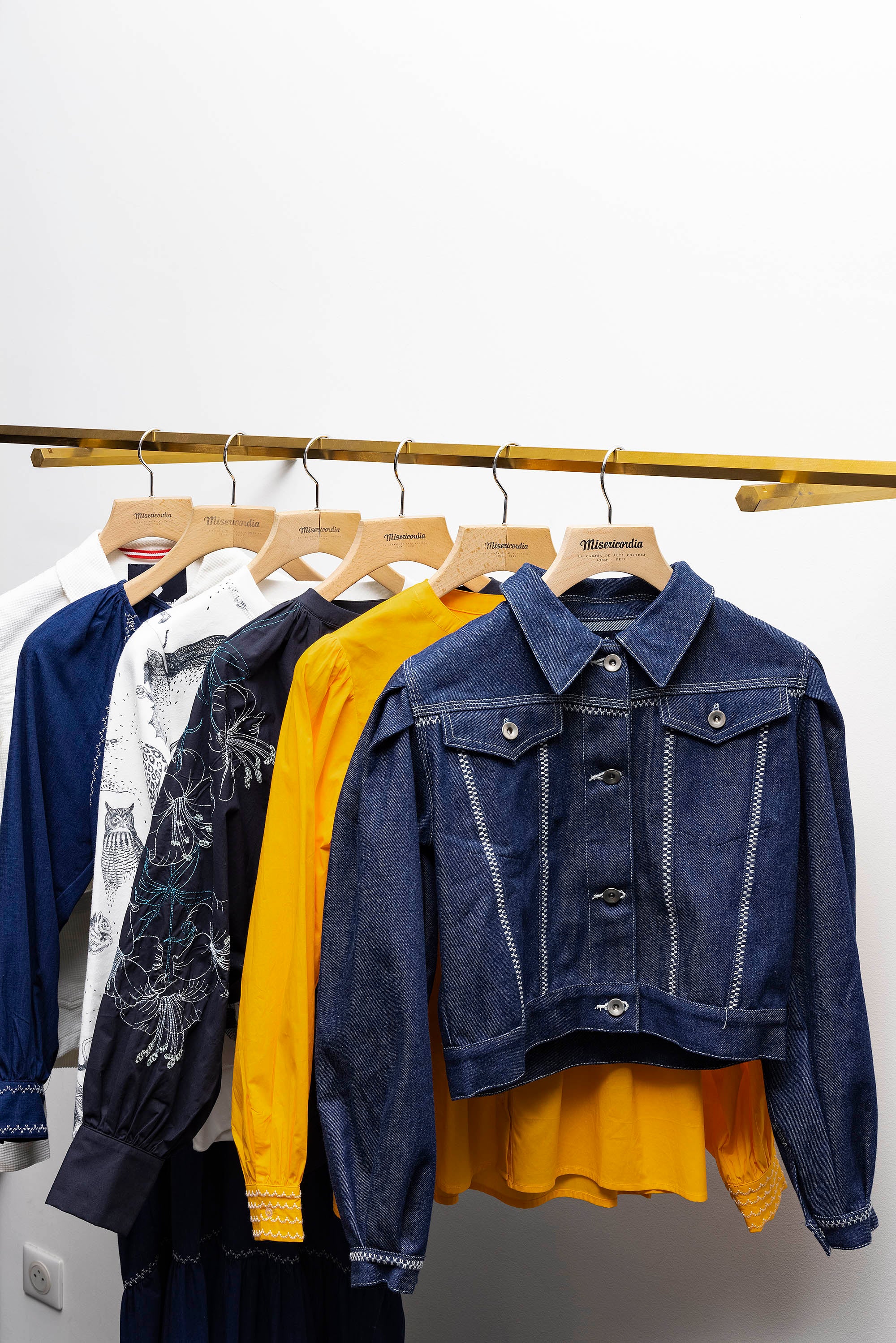 photography of the misericordia clothing store on hangers and on a white background lima peru