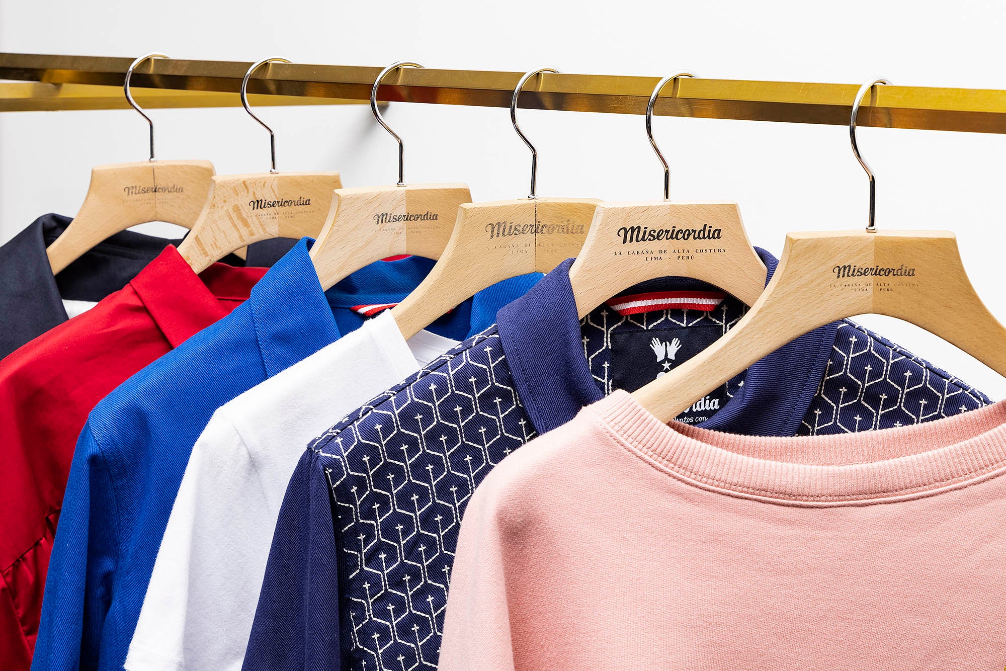 photography of the misericordia clothing store on hangers and on a white background lima peru