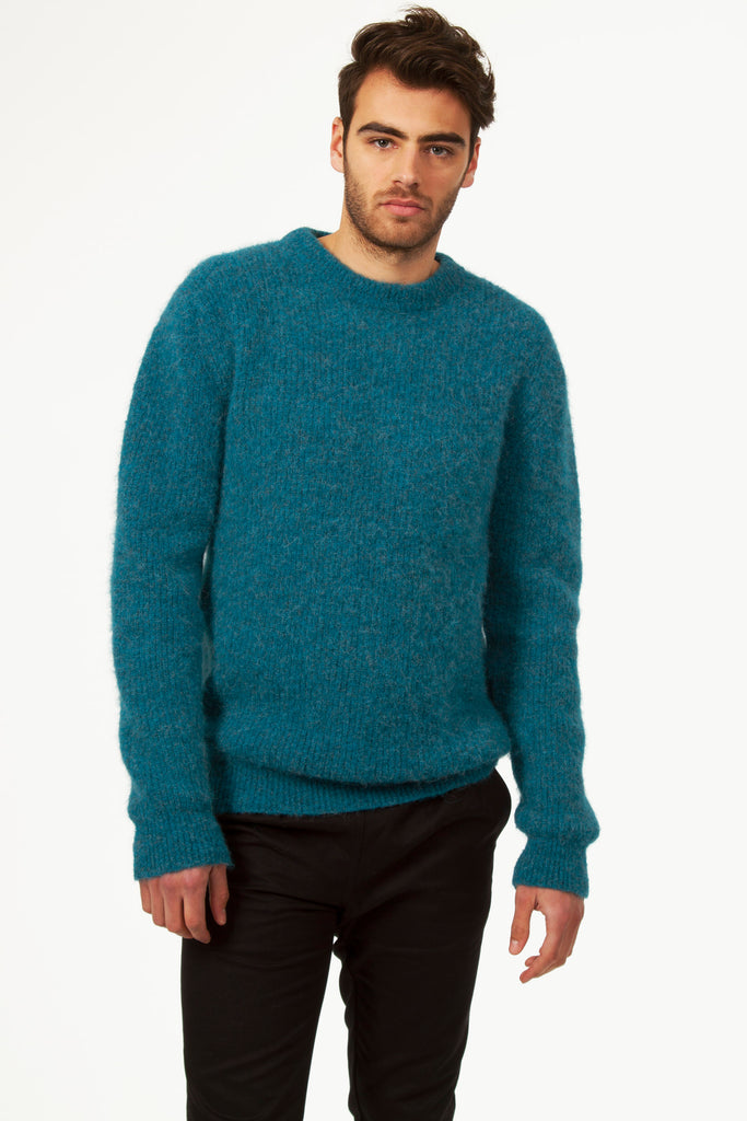 Male mannequin taking a break in a blue lagoon alpaca wool sweater thick knit round neck casual male wardrobe for the city or going on weekends