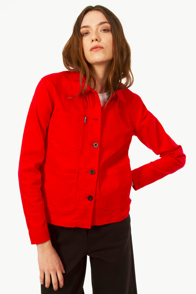 Young woman in a red blue cotton work jacket buttoned in authentic Parisian style, iconic pieces trendy shopping