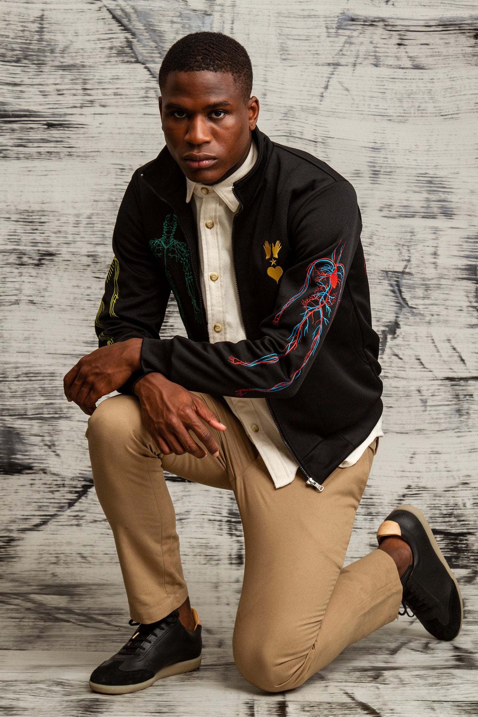 black sports jacket in cotton and polyester with human body embroidery on the back