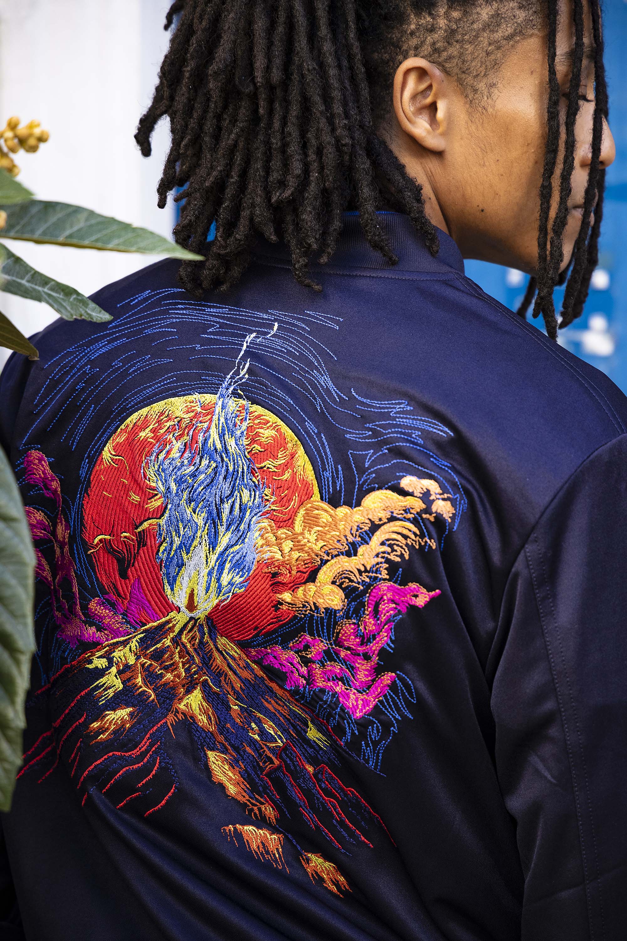 Navy souvenir bomber jacket with volcano embroidery on the back, two front pockets and zipper