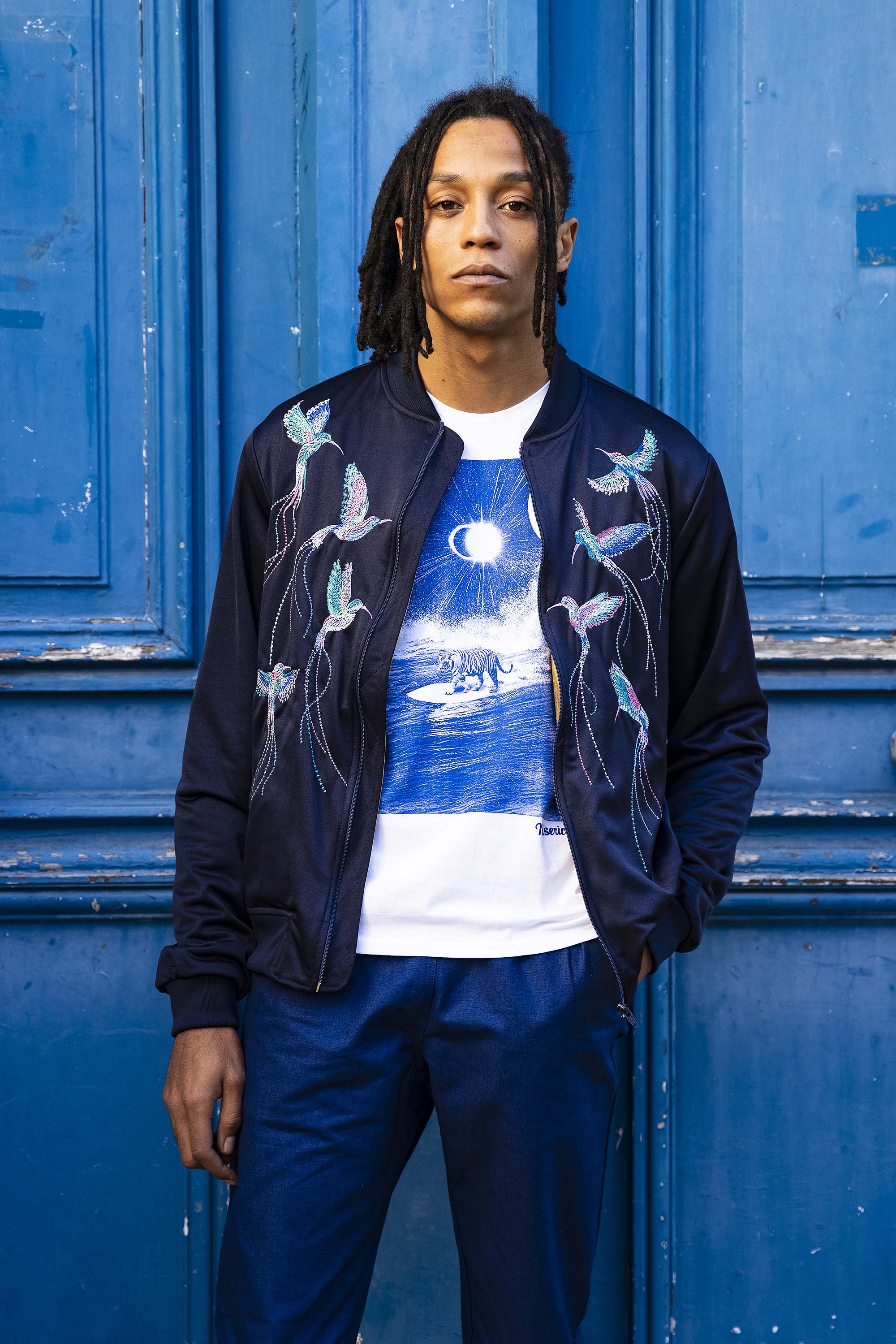 Navy souvenir bomber jacket with hummingbird embroidery on the front and back, zip closure and front pockets