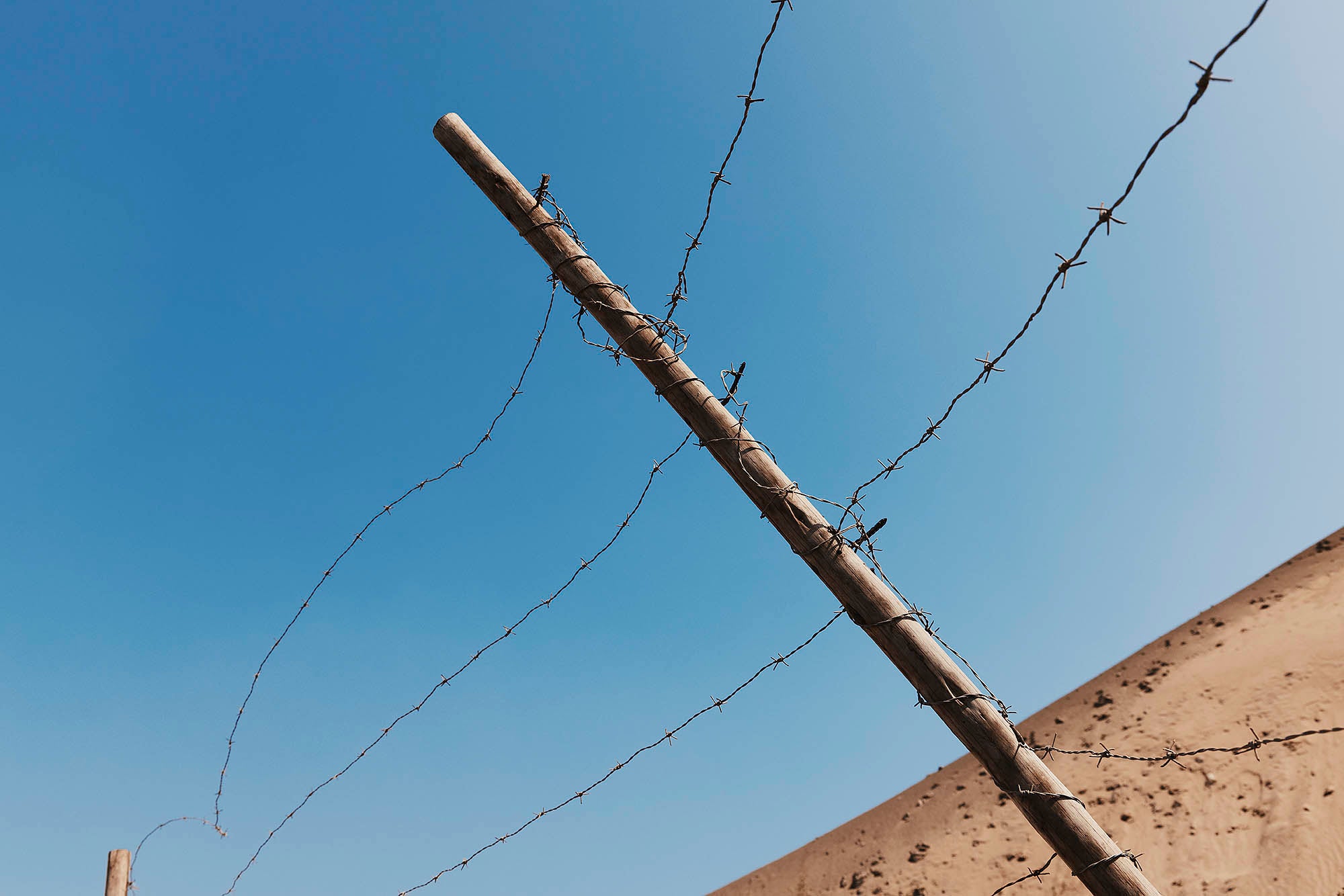 photograph of barbed wire taken from loans in detail Lima Peru Landscape Slums city light architecture desert wave