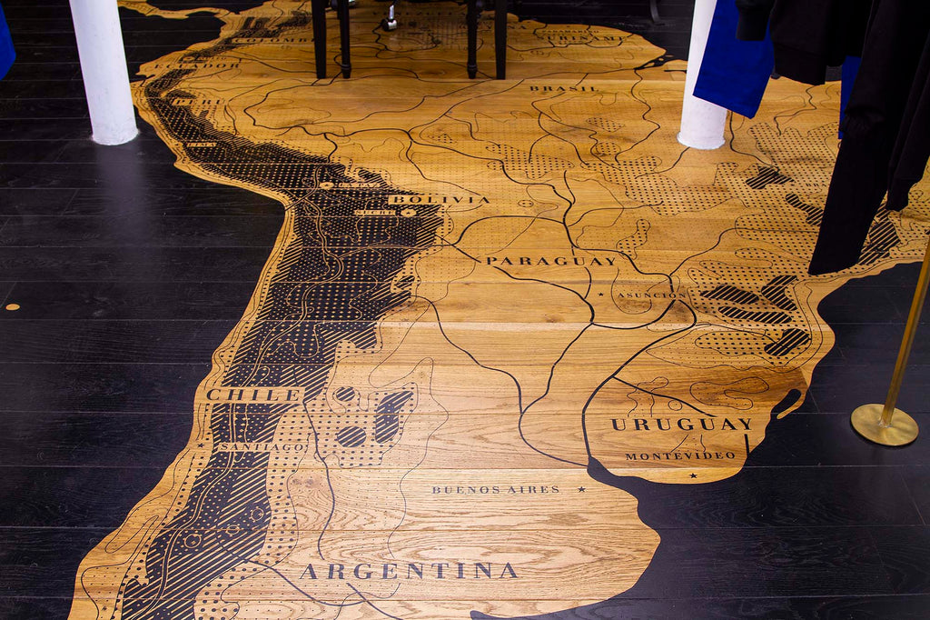 Parquet detail interior shop in Paris Latin America map natural materials respect for the environment committed fashion