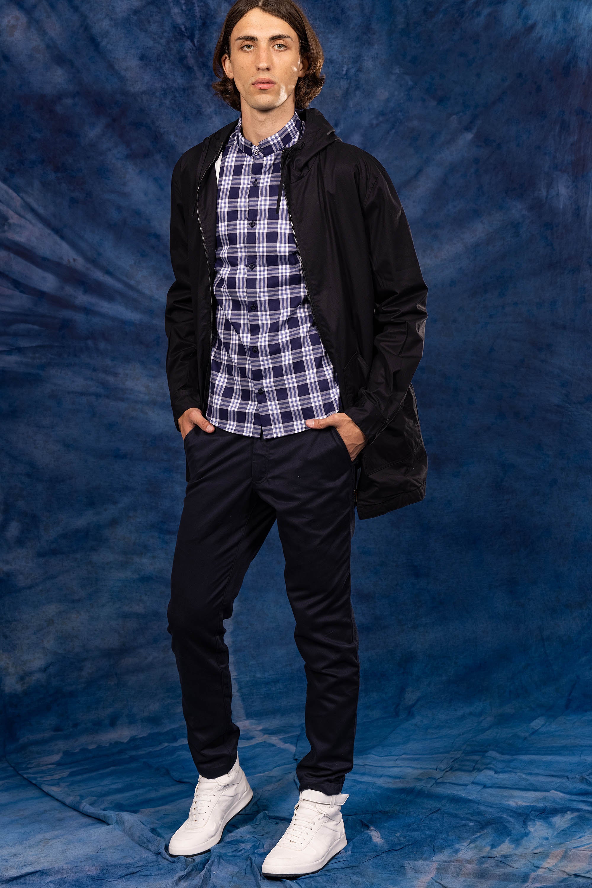 black coat over a navy blue plaid shirt for the new summer 2023 misericordia collection