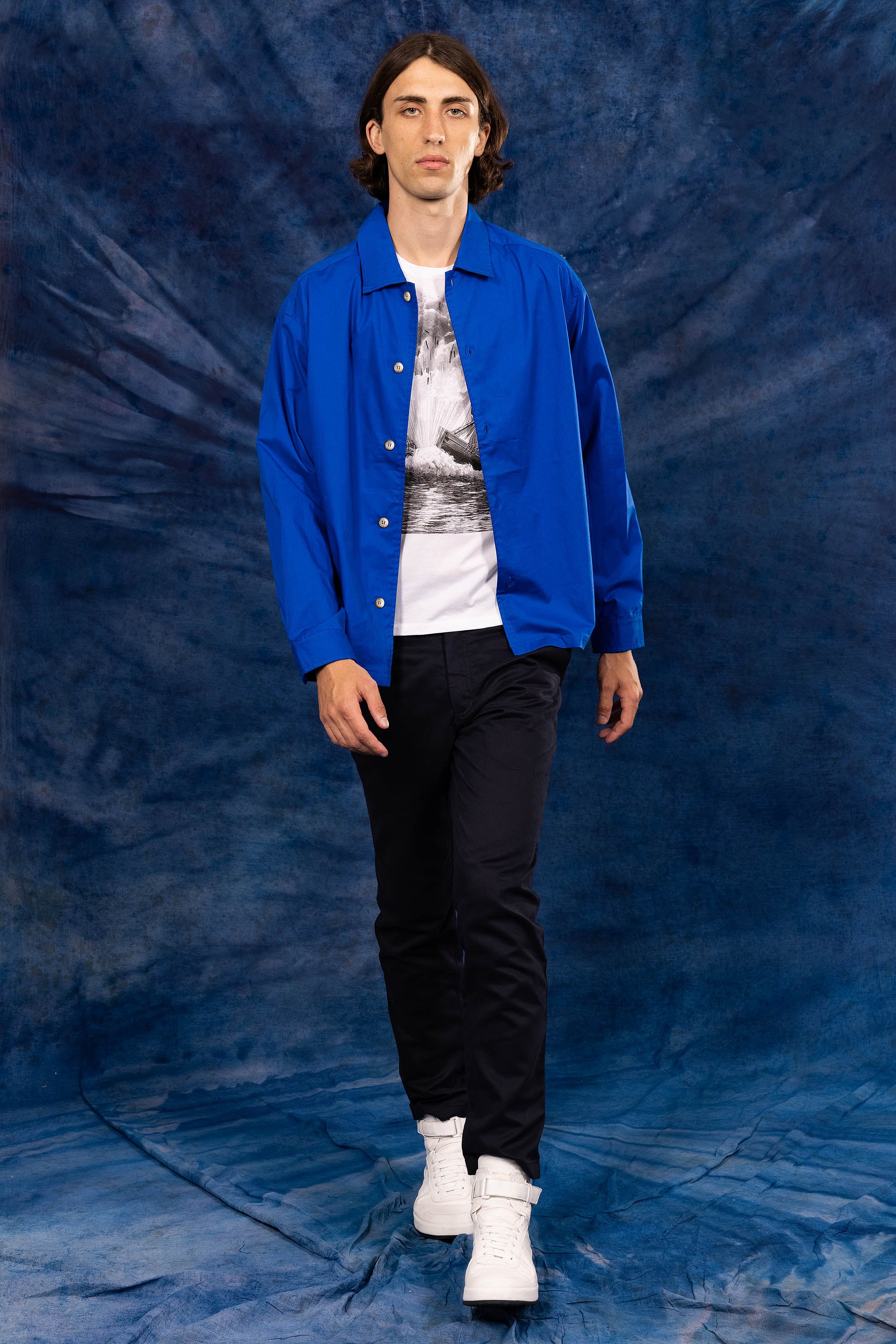 sapphire blue shirt over a white t-shirt photography on a blue background new summer collection 2023 misericordia