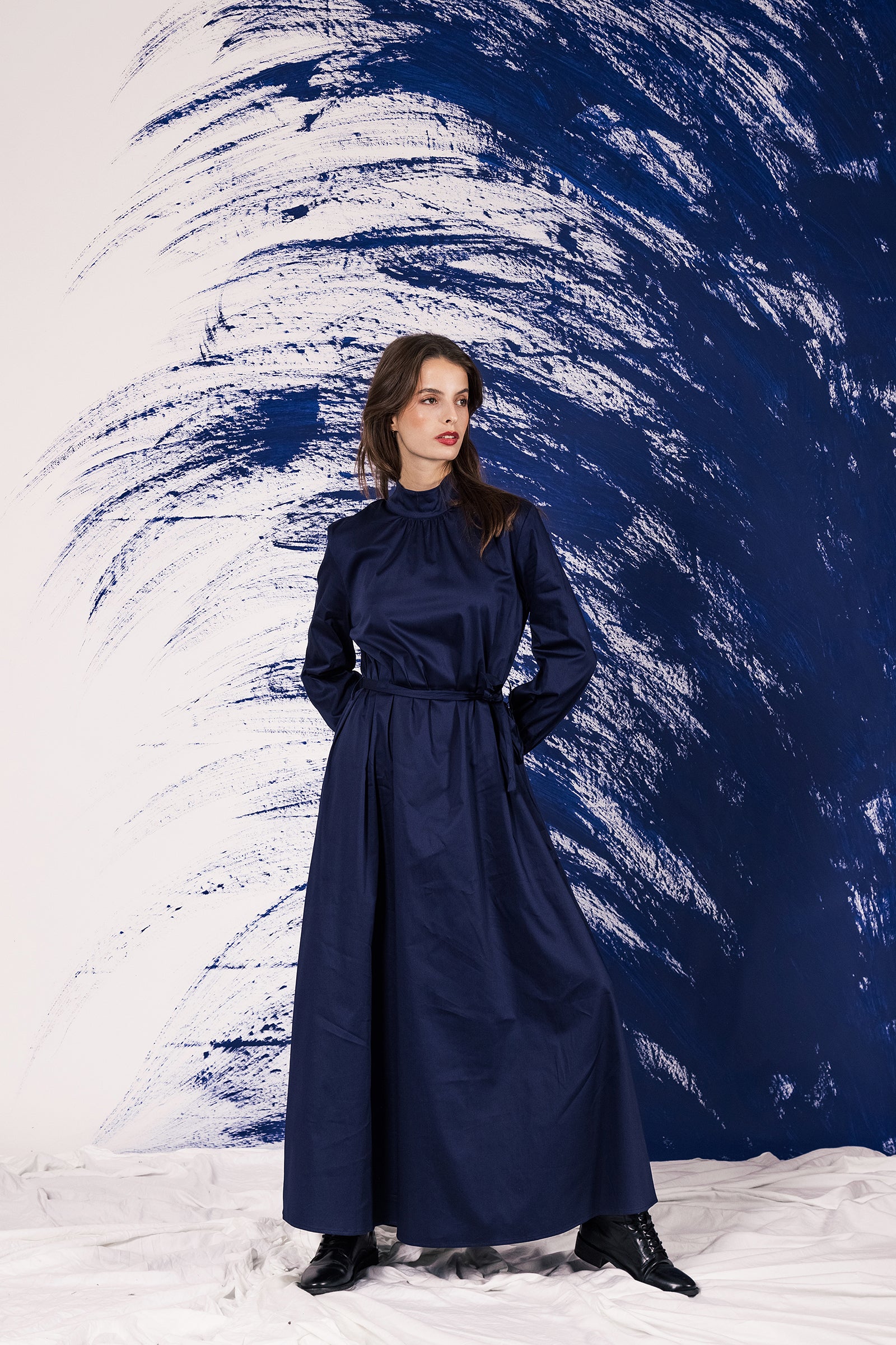 woman wearing navy blue agatha dress loose long sophisticated look high neck feminine cotton durable piece misericordia lima peru