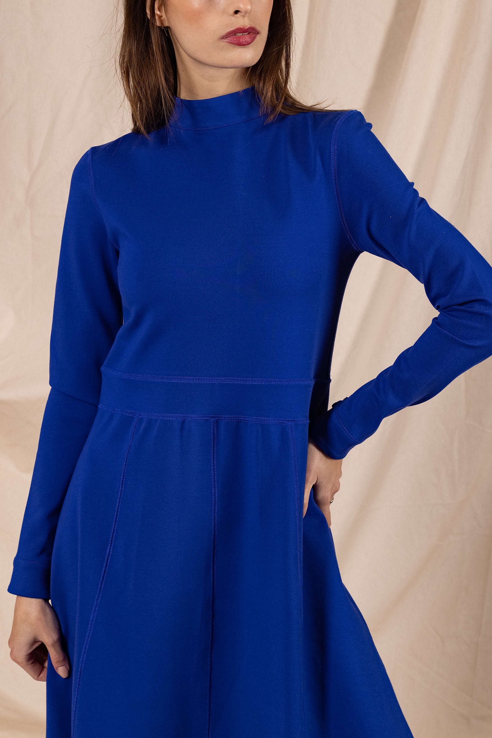 woman wearing sapphire blue bohemia dress long high neck fitted waist soft cotton and polyester fabric feminine winter warm misericordia peru lima