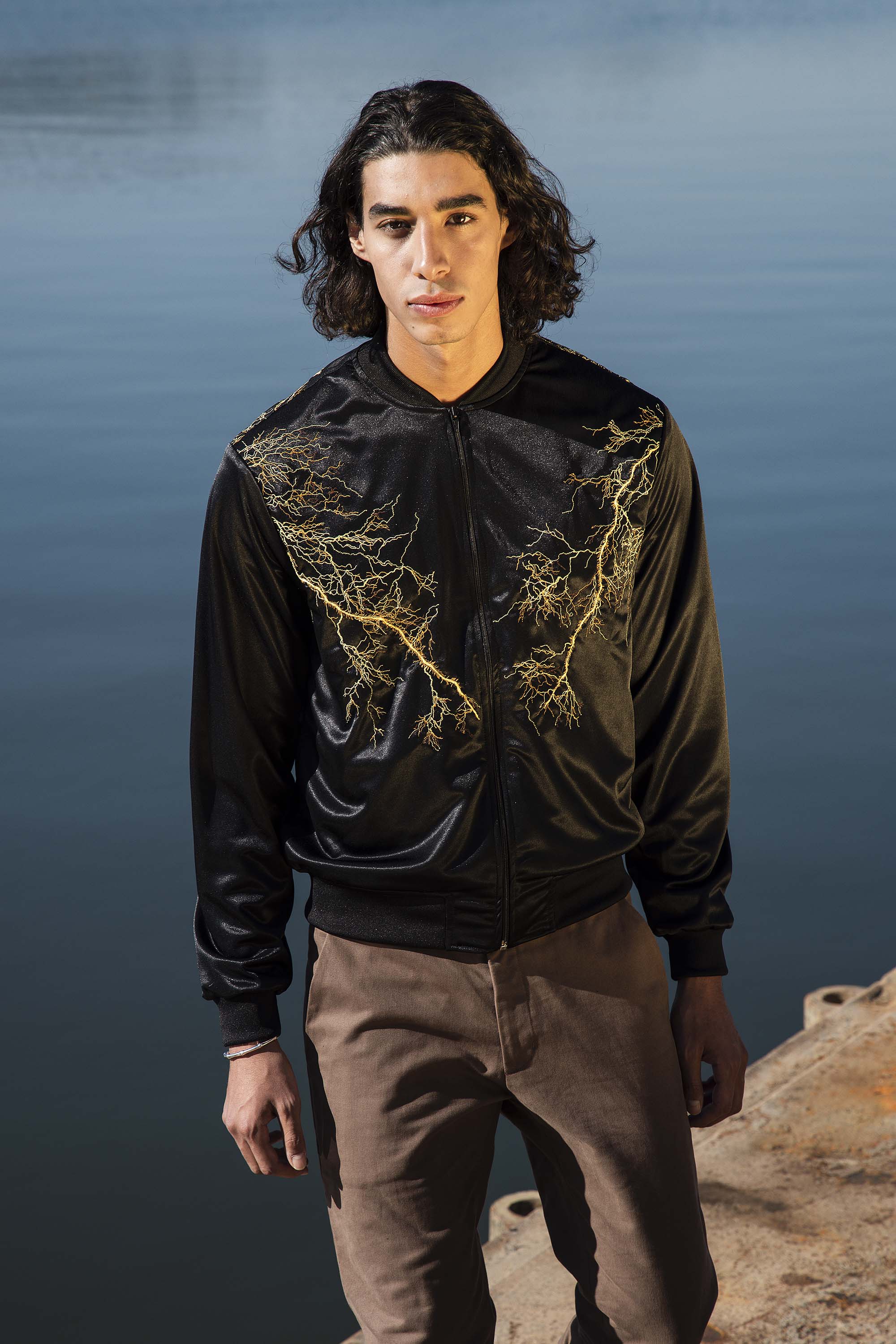 Black polyester souvenir bomber jacket with lightning embroidery and front pockets