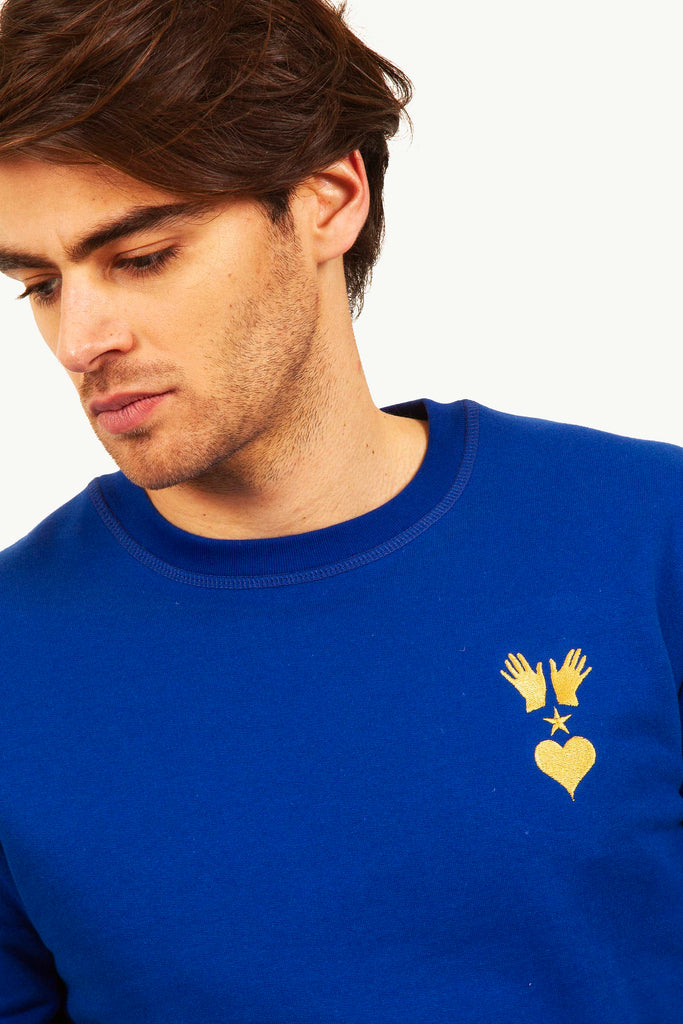 sweatshirt with the misericordia logo hand heart and spirit for men with hair in a photo studio
