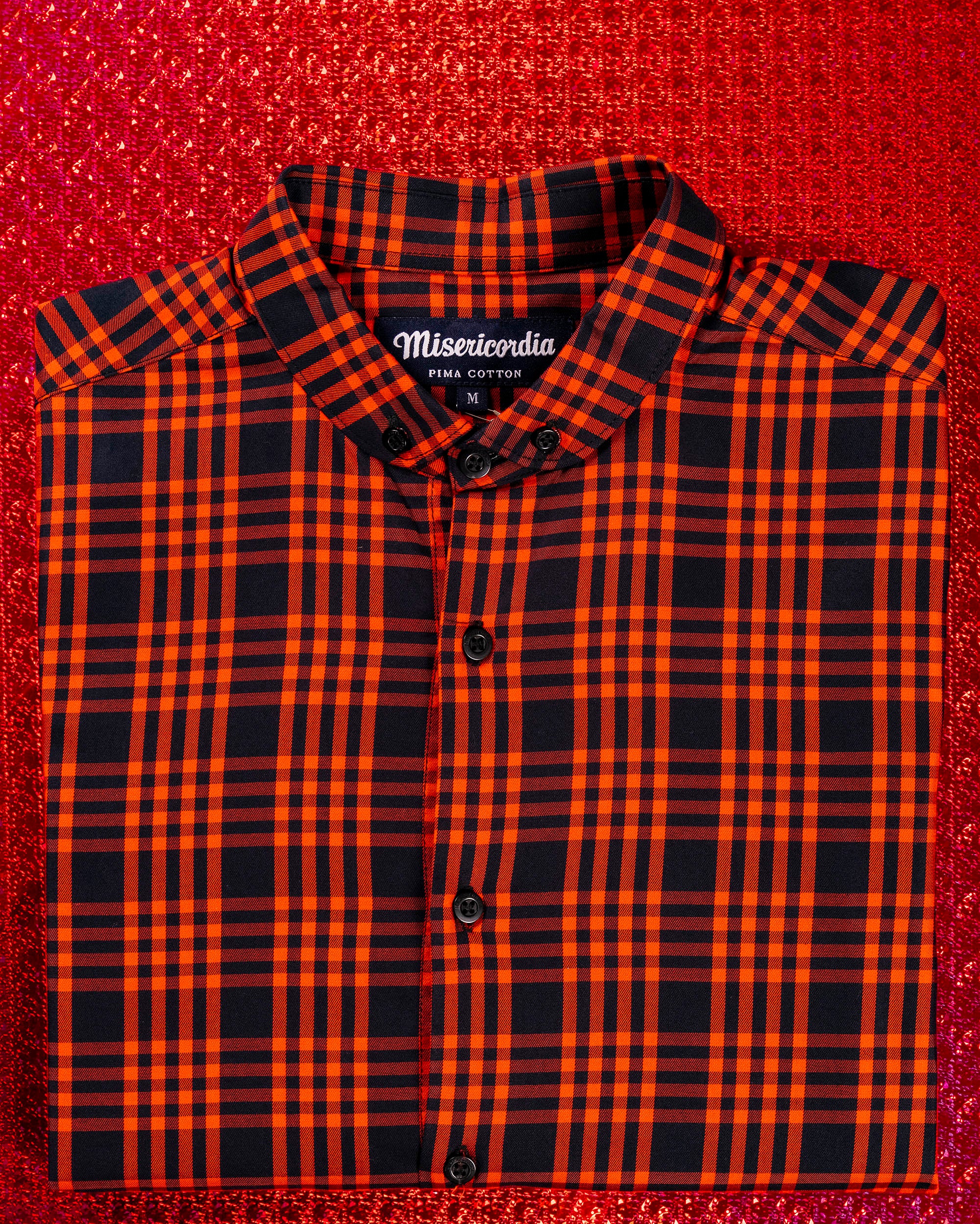 orange plaid print shirt with rounded collar in folded oxford cotton on a red background gift idea for christmas