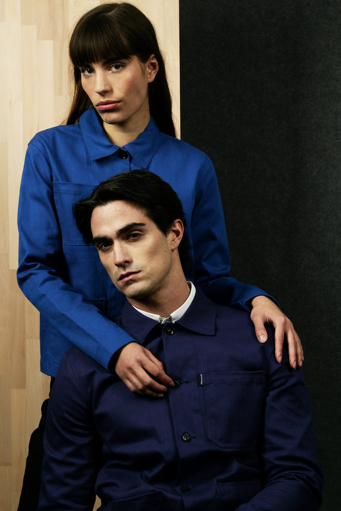 Mode couple duo pose pour shooting photo bleu veste de travail cristobal mains épaules fond bicolore