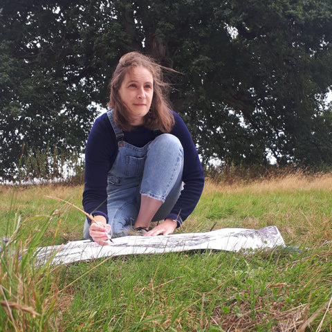 Alice Savery sketching outside on a huge piece of paper Alice Draws the Line