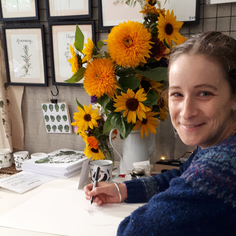 Alice drawing the sunflower bouquet at Malvern Autumn Show, Alice Draws the Line raffle prize