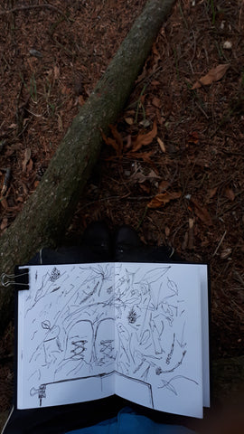 sketching under a Greek pine