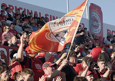 Crowd waving the Adelaide United flag