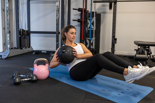 Crafting A Joyful Fitness Routine: Your Guide To Success - woman doing situps with a gym ball