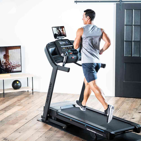 Man running on his home gym treadmill