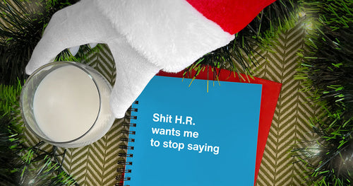 Santa's hand reaching for a glass of milk next to a WTF Notebook