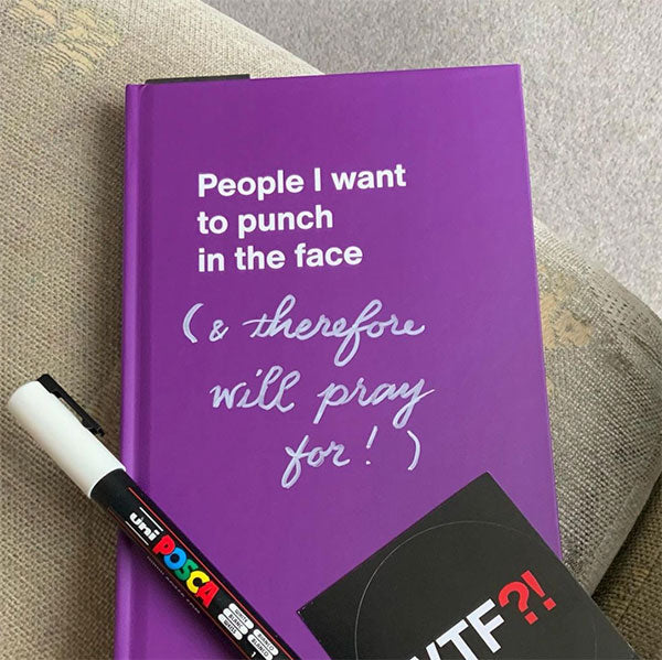 A purple WTF Notebook and sticker