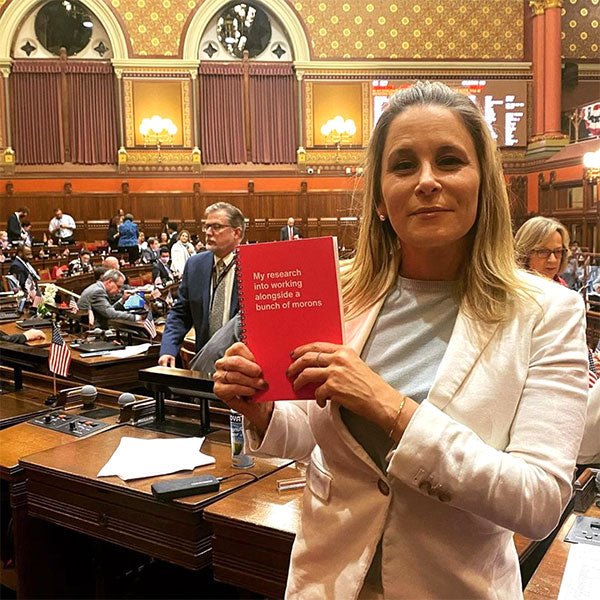 A woman posing with her WTF Notebook inside Connecticut State Capitol