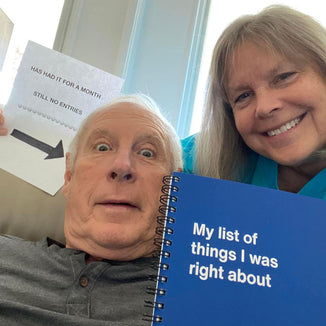 A senior couple joking with their WTF Notebook 