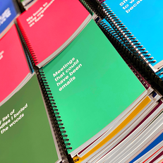 A stack of softcover notebooks in production
