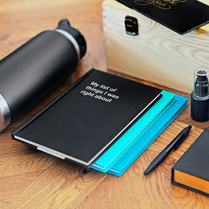 A collection of corporate gifts, with WTF Notebooks as the perfect funny business present