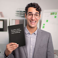 A happy business man holding his WTF Notebook gift