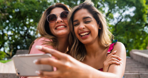 Two young women laughing together