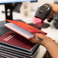 Hands holding a WTF Notebook, scanning it for delivery