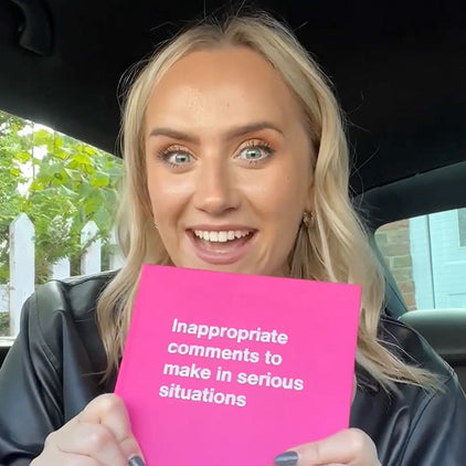 A happy young woman with a pink WTF Notebook