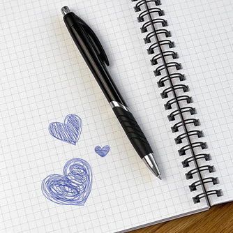 An open gridded WTF Notebook showing three hearts drawn with a ballpoint pen